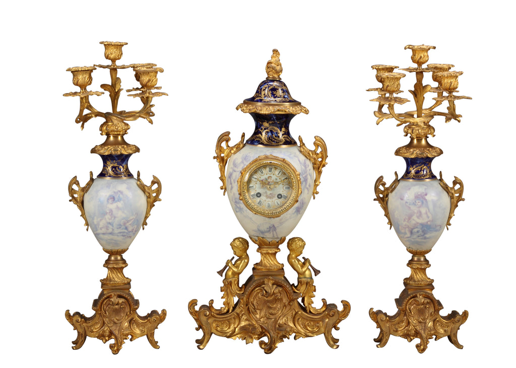 A FRENCH SEVRES STYLE WHITE PORCELAIN & GILT BRONZE CLOCK GARNITURE, 19TH CENTURY