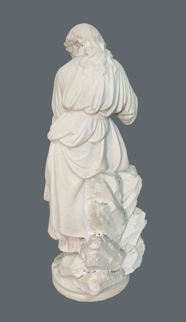 marble figure of a lady sitting on rocks
