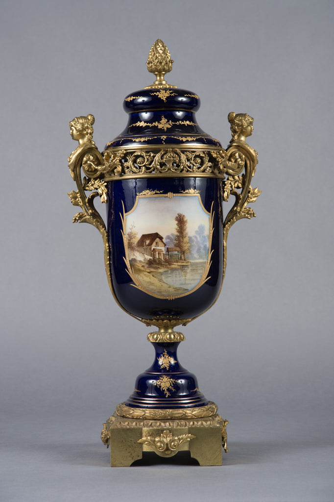A PAIR OF SEVRES STYLE GILT BRONZE MOUNTED VASES