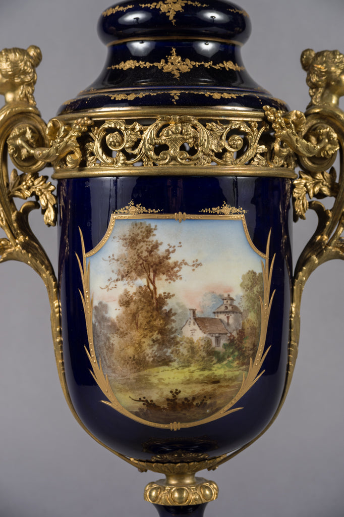 A PAIR OF SEVRES STYLE GILT BRONZE MOUNTED VASES
