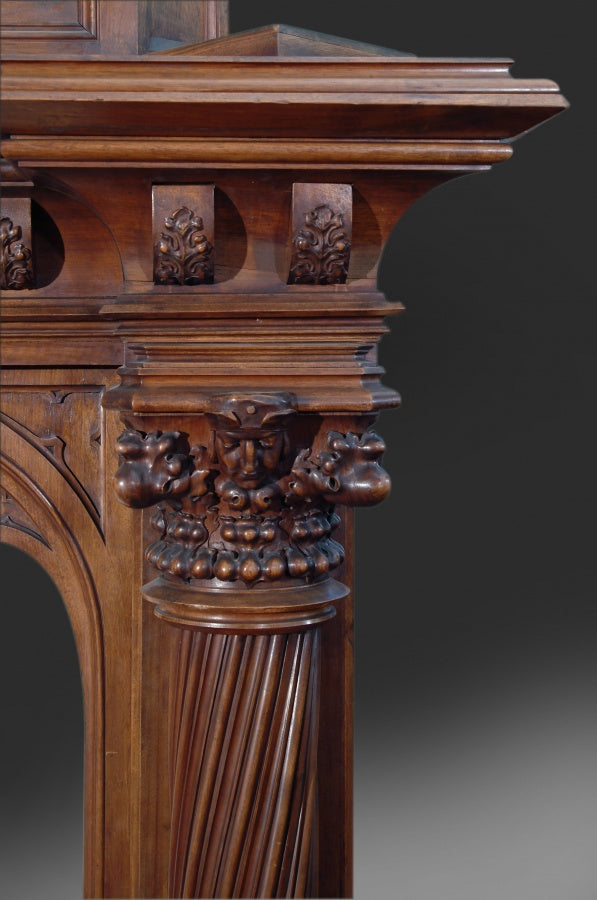 A MONUMENTAL ENGLISH GOTHIC STYLE CARVED WALNUT FIREPLACE